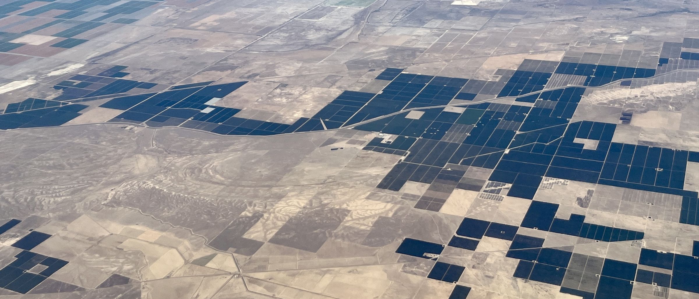 Irrigated cropping blocks seen from altitude, each a distinct rectangle against dry ground